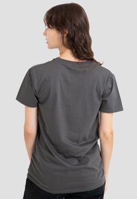 Graues Baumwoll-T-Shirt mit kurzen Ärmeln, Rundhalsausschnitt, weicher Textur und lockerer Passform. Sichtbare Nahtdetails und schlichtes Design.