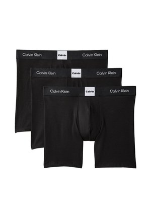 Un set di tre boxer in cotone nero, con una vita elasticizzata marchiata con il nome "Calvin Klein" in lettere bianche.