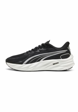 Black running shoe with a breathable mesh upper, white midsole, and silver accents. Features laces and textured grip on the sole.