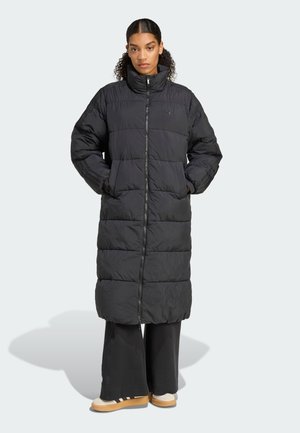 Long black puffer coat with a high collar, zip closure, and horizontal quilted pattern. Features side pockets and elasticized cuffs.
