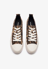 Leopard print canvas sneakers with white rubber toe caps and laces. Smooth texture, low-top design with rear pull tab for easy wear.