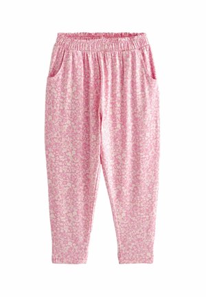 Pantalon rose à petit motif floral blanc, taille élastique et poches latérales, présenté à plat sur fond blanc.