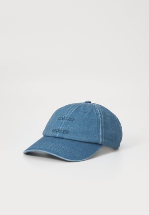 Blue denim baseball cap with embroidered brand name, curved brim, six-panel design, and adjustable strap at the back.