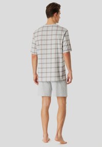 Gray plaid short-sleeve shirt with light brown lines paired with light gray shorts, made from soft cotton blend material.