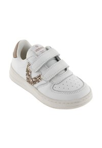 Weiße Kindersneaker mit zwei Klettverschlüssen, beigem Fersenakzent und glitzerndem goldenen Zickzackdetail an der Seite.