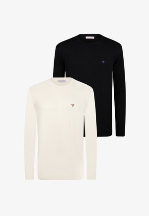 Zwei Rundhals-Pullover: einer in Schwarz mit einem lila Vogel-Logo und einer in Creme mit einem braunen Vogel-Logo. Beide besitzen lange Ärmel und gerippte Bündchen.