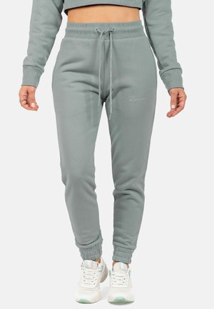 Light green joggers made from soft material, featuring an elastic waistband with drawstring, side pockets, and fitted cuffs.