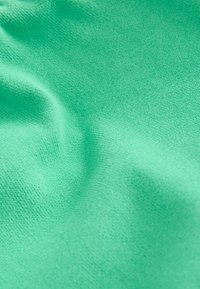 Tissu texturé à une couche, d'un vert turquoise vif, avec un aspect lisse et légèrement élastique. Pas de motifs ou de matériel visibles.