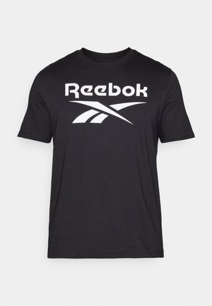 Must alusärgi täiesti must, suur valge Reebok logo rinnal, ümar kaelus ja lühikesed varrukad. Pehme tekstuur, standardne lõige.