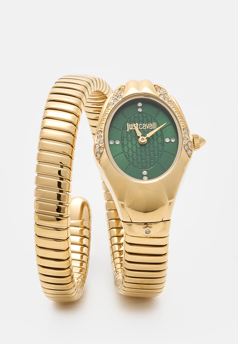 Goudkleurige spiraalhorloge met een groene gedecoreerde wijzerplaat, accentueert met rhinestones; gebogen, flexibele armbandontwerp.