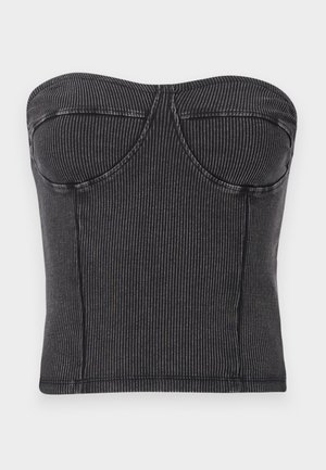 Haut sans bretelles noir en tissu côtelé, avec une coupe ajustée, des coutures courbes et une texture lisse. Pas de fermetures ni d'ornements visibles.