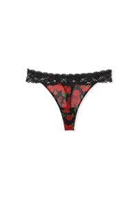 Lacy black thong with red floral pattern on sheer fabric, featuring scalloped lace trim at the waistband. Thin sides and V-shaped back.