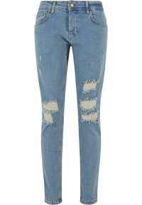 Világoskék, slim fit farmernadrág, több szakított részlettel és rojtos széllel. Denim anyagból készült, klasszikus öt zsebes dizájnnal.