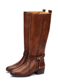 Stivali alti fino al ginocchio in pelle marrone con tacco leggero, caratterizzati da un dettaglio con fibbia e una texture liscia, progettati con una punta arrotondata.