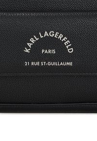 Black textured leather with embossed silver text: "KARL LAGERFELD," "PARIS," and "21 RUE ST-GUILLAUME." Rectangular shape, minimalistic design.