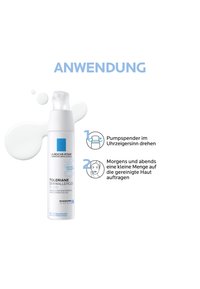 White pump bottle of La Roche-Posay Toleriane Dermallergo Fluid with lotion spilled, instructions in German for use and pump direction.