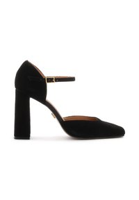 Black suede block-heeled pumps with a pointed toe and a single ankle strap featuring a gold buckle accent. Smooth texture and elegant silhouette.