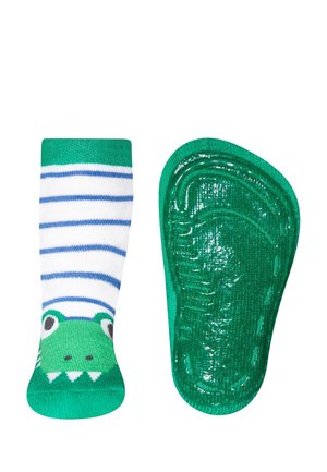 Grün-weiße, gestreifte Socke mit einem Froschgesicht-Design. Die Sohle ist einfarbig grün mit einer strukturierten, rutschfesten Oberfläche.