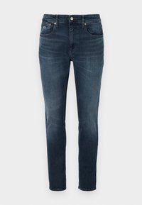 Mörkblå denimjeans med smal passform, fem fickor, subtil blekning och en metallknappstängning. Har en liten logotyp på bakfickan.