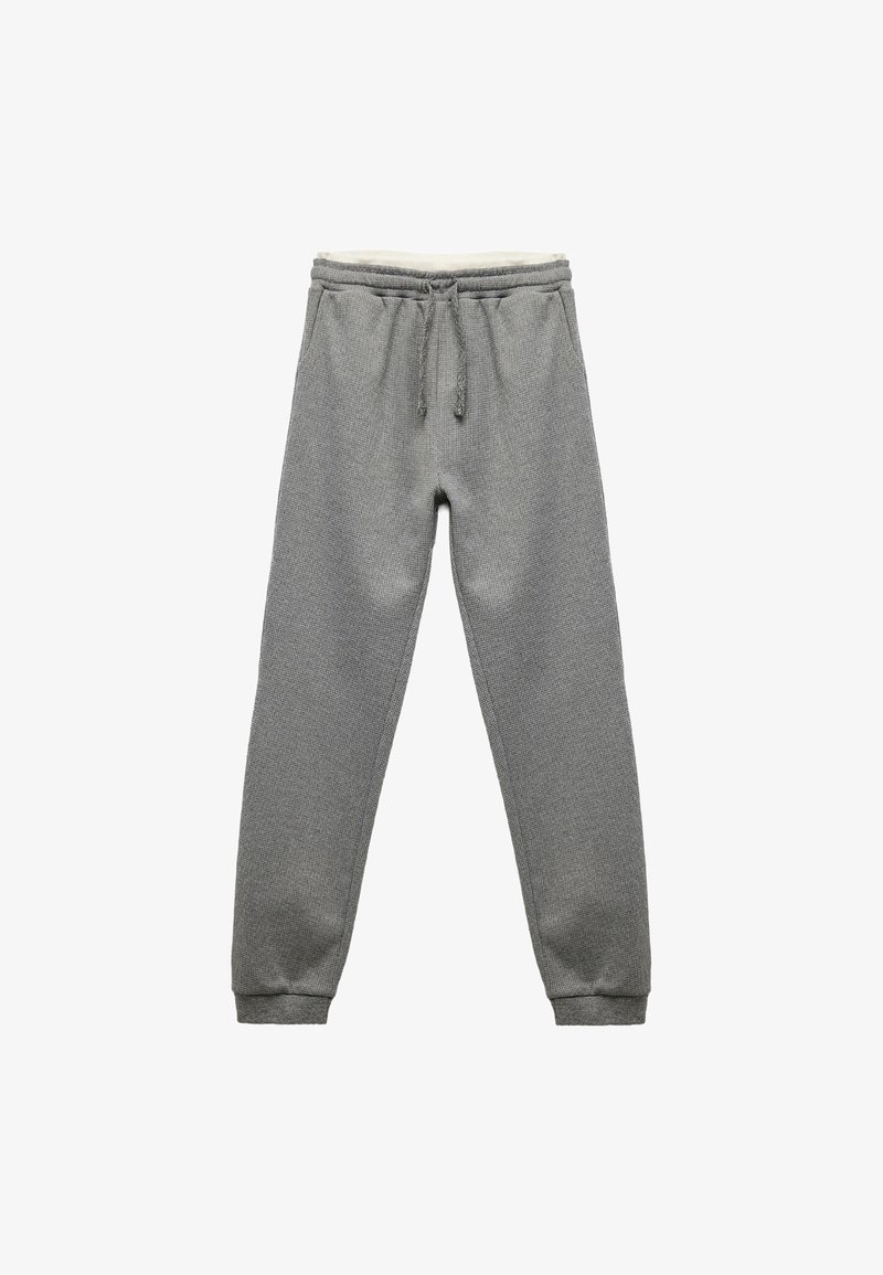 Grå sweatpants med en tekstureret stof, elastisk talje, snortræk og ribbede manchetter. Designet til komfort og afslappet brug.
