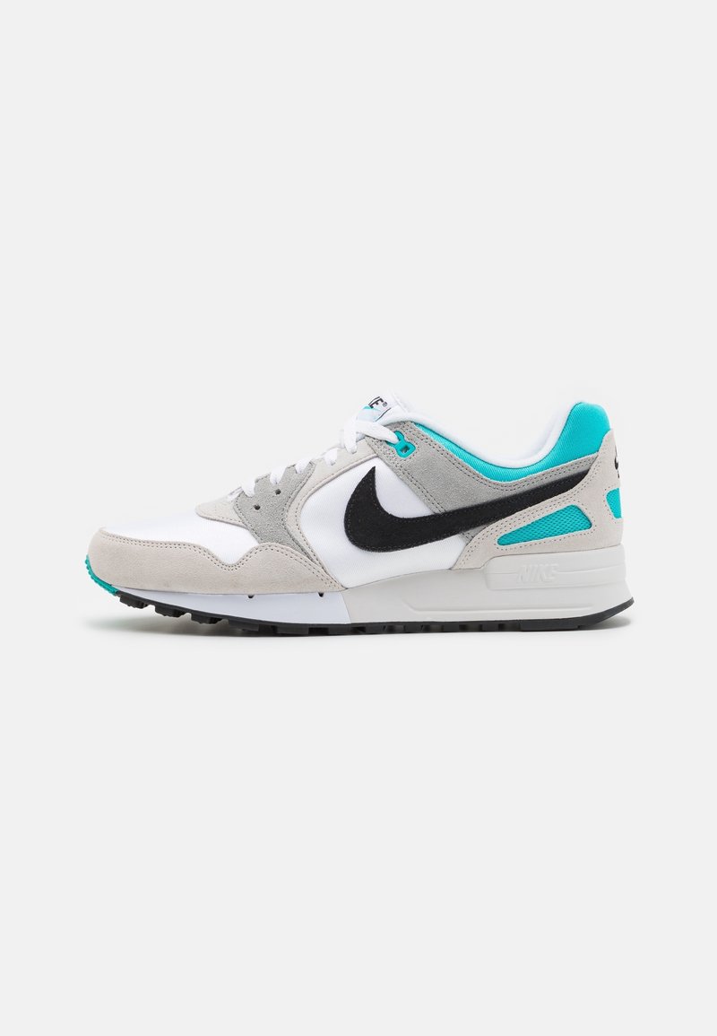 Nike sneaker with a white mesh and grey suede upper, black swoosh, turquoise accents, and textured sole. Side view.