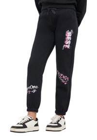 Pantaloni sportivi neri con vita a coulisse, caratterizzati da grafiche colorate "BEST" e "FRIENDS Forever" in rosa e bianco. Fondo a costine.