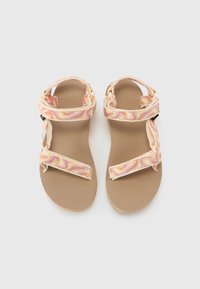 Tan sandals with a textured sole and multicolored patterned straps. Features two adjustable Velcro closures on the top.
