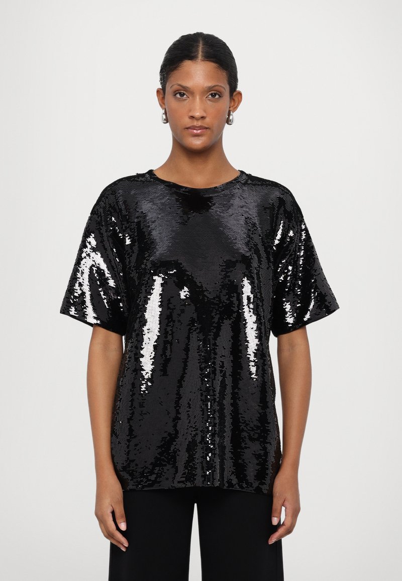 Black short-sleeve top made of sequined fabric, featuring a loose fit and round neckline, with shiny, reflective surfaces throughout.