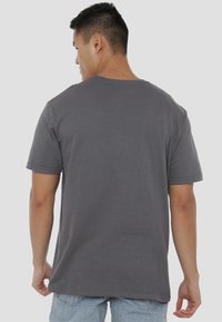 Gray cotton t-shirt with a crew neckline and short sleeves, featuring a relaxed fit and smooth texture, viewed from the back.