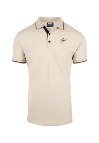 Beige polo shirt van katoen met een zwarte kraag en afwerking. Beschikt over drie knopen en een zwart logo op de borst.