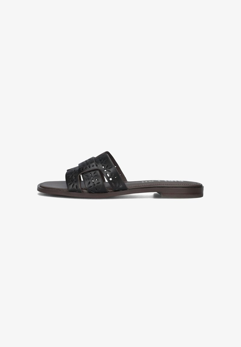 Black slip-on sandals with cut-out floral pattern on straps, flat sole, and a smooth synthetic finish. Brown sole provides contrast.