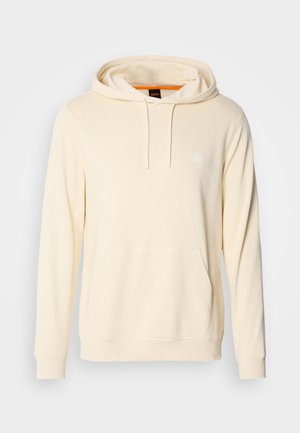 Cremefarbener Kapuzenpullover aus weichem Stoff, mit einer Fronttasche, Kordeln und einem kleinen Logo auf der Brust.