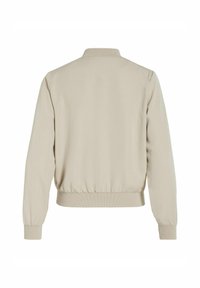 Veste bomber beige à manches longues avec col, poignets et taille côtelés, vue de dos sur fond blanc.