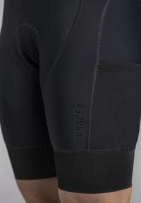 Black cycling shorts with a tight fit, featuring textured panels, flat seams, and a visible "BIORACER" logo. Reinforced leg openings.