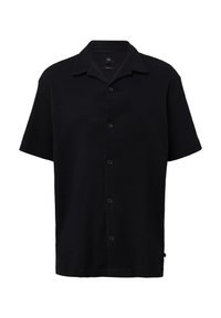 Chemise noire à manches courtes, boutonnée, en tissu texturé. Elle dispose d'un col classique et de boutons sur le devant, avec une coupe décontractée.