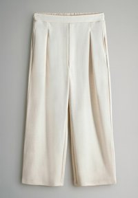 Beige weit geschnittene Hose mit einem gerafften elastischen Bund, verfügt über zwei Seitentaschen und dezente Falten an der Vorderseite für zusätzliche Details.