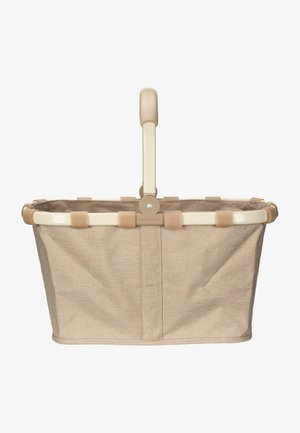 Panier de shopping en tissu beige avec un cadre en métal crème et une poignée texturée. Comprend des sangles en tissu maintenant le panier au cadre.