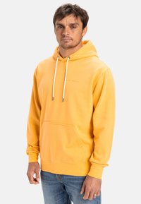 Yellow hooded sweatshirt with a front pocket, white drawstrings, and ribbed cuffs. Features subtle branding on the chest area.