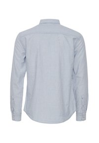 Light blue and white striped long-sleeve shirt with a collar, button placket, and single-button cuffs. Smooth fabric, relaxed fit, curved hem.