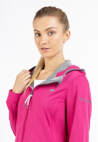 Fuchsia zipjacka med grå huva, snodddekor och broderad detalj på ärmen. Slätt tyg med en åtsittande design.