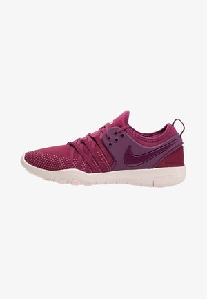 Chaussure de course Nike bordeaux et pourpre avec semelle blanche, bout en mesh, lacets croisés et logo Nike swoosh sur le côté.