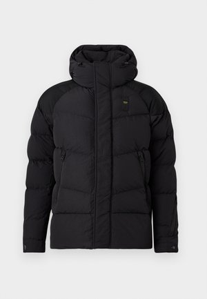 Black puffer jacket with a high collar, featuring oversized quilted sections, side zip pockets, and contrasting black shoulder panels.