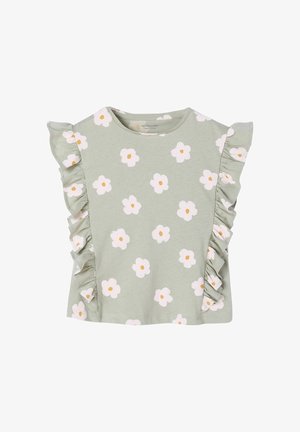 Hellgrünes Kleinkind-Oberteil mit weißen und gelben Blumenmustern sowie gerafften Details an den Seiten und Ärmeln.