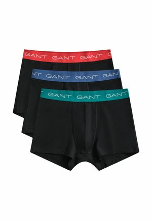 Drei schwarze Boxershorts übereinandergestapelt, jede mit einem andersfarbigen Bund in Rot, Blau und Grün, alle mit dem Schriftzug "GANT" gebrandet.