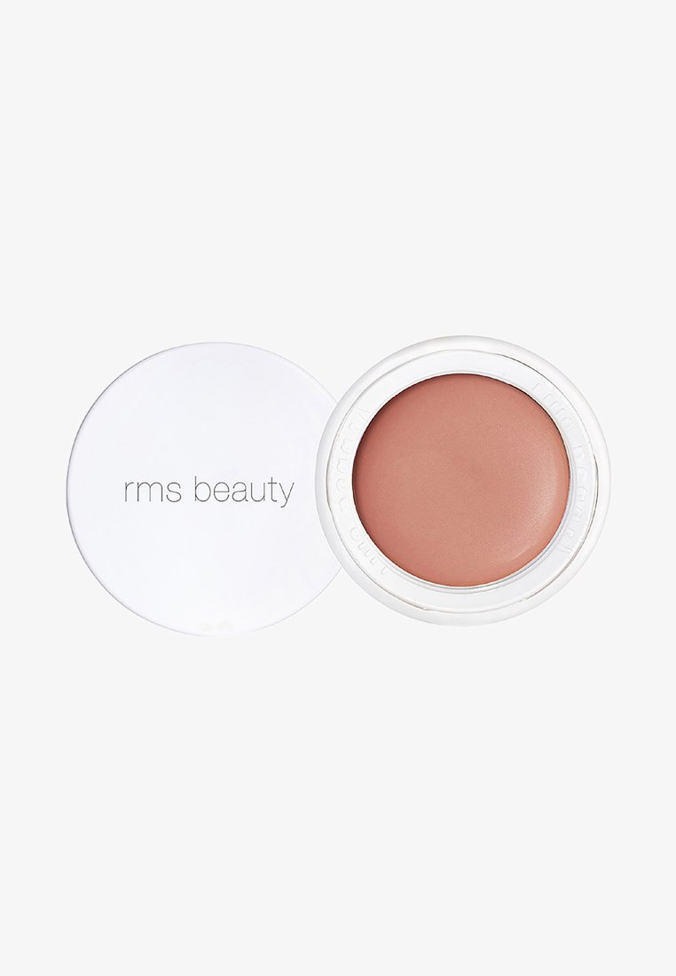RMS Beauty Creme Blush in einem runden, weißen Behälter, der einen sanften matten pfirsichrosa Farbton mit einer glatten Textur und glänzenden silbernen Akzenten zeigt.