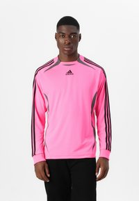Long-sleeve athletic shirt in bright pink, made from lightweight fabric. Features black and gray stripes on sleeves and logo at the center.
