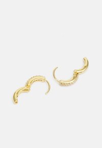 Gold hoop earrings with a curved design, featuring a row of clear gems along one side. Smooth texture with shiny finish.
