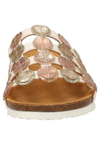 Mehrfarbige Sandale mit metallischen, runden Verzierungen, einem weißen Untergrund und einer korkähnlichen Sohle. Offene Zehenpartie mit einem geflochtenen Obermaterial.