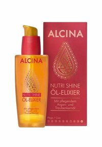 Alcina Nutri Shine Oil-Elixir in a transparent amber bottle with a gold pump top, accompanied by a red box featuring decorative patterns.