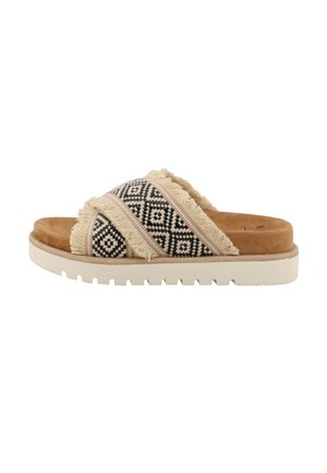 Woven fabric slide sandals with fringe detail, featuring a geometric black and beige pattern, tan suede insole, and a white rubber sole.